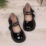 Ballerines noires avec détails en vernis et nœud